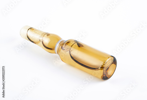 Single Amber Glass Medical Vial Lying on White