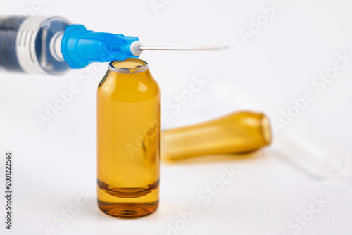 Syringe Needle Over Open Amber Medical Ampule