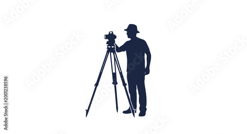 Photographer Standing with Camera on Tripod.