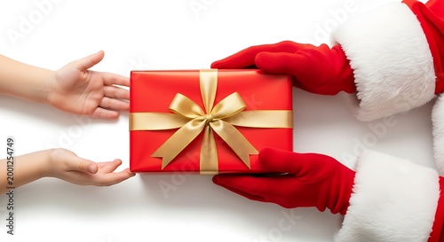 Gift wrapped in red paper with gold ribbon being given from Santa Claus to a child on a white background during Christmas.