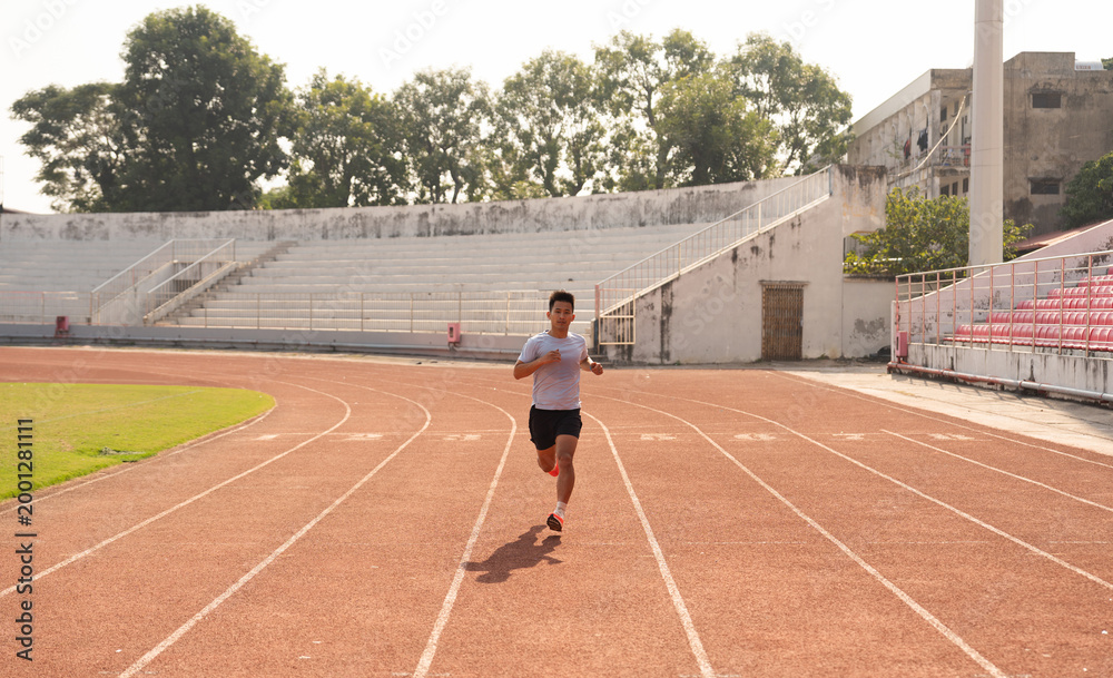 Fototapeta premium Focused athlete sprints on a track pushing limits in an empty stadium aiming for personal best