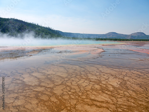 Grand Prismatic Spring orange volcanic surface, with stream rising from hot thermal water in Yellowstone National Park