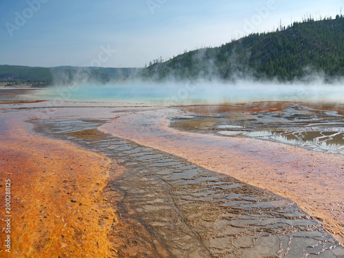 Grand Prismatic Spring orange volcanic surface, with stream rising from hot thermal water in Yellowstone National Park