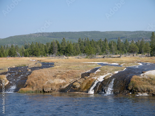 Firehole river banks with hot water creeks runoff from geysers in Yellowstone national park