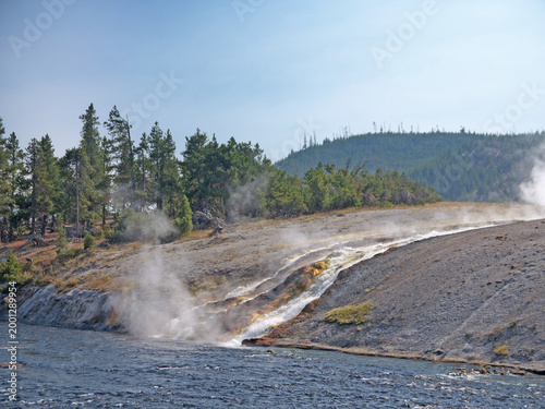 Firehole river banks with hot water creeks runoff from geysers in Yellowstone national park