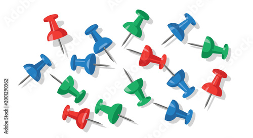 A selection of red, blue, and green push pins with metallic points is spread out across a white background, highlighting a organized set of tools for marking maps or office documen