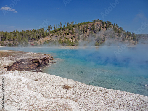Excelsior Geyser pool with Steam rises from turquoise hot spring water  in Yellowstone National park
