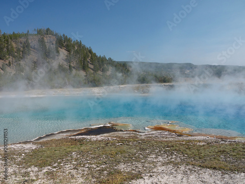Excelsior Geyser pool with Steam rises from turquoise hot spring water  in Yellowstone National park