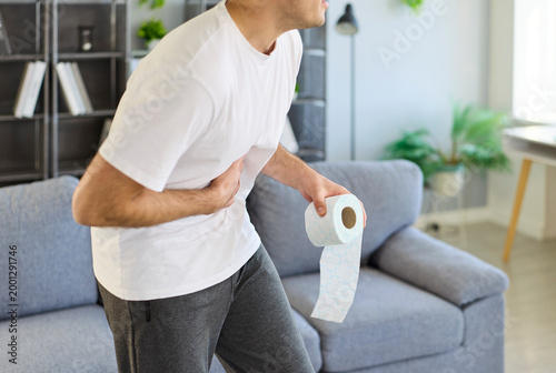 Tableau sur toile Man with diarrhea clutching abdomen in pain