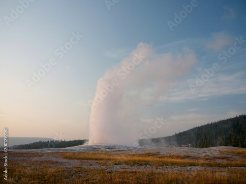 Old Faithful Geyser evening eruption in Yellowstone National park