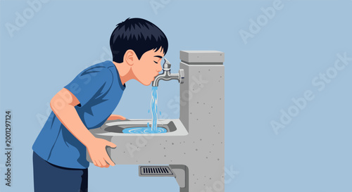 Boy drinks water from public fountain