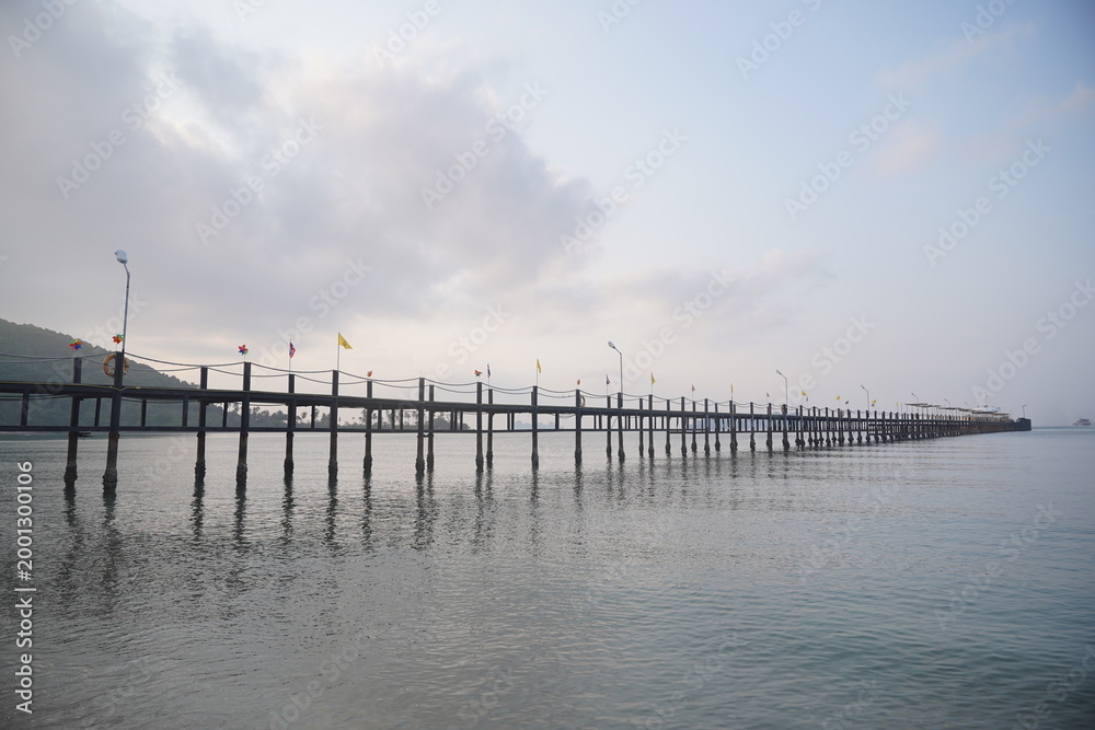 Fototapeta premium Minimal seascape with pier and soft cloudy sky