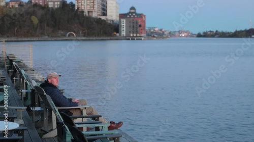 Stockholm, Sweden A man walks at dawn by the Baltic Sea seaside in the Nacka Strand district.  