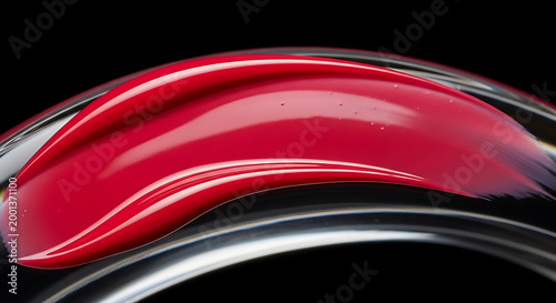 Glossy red and silver curved shapes against black background abstract design