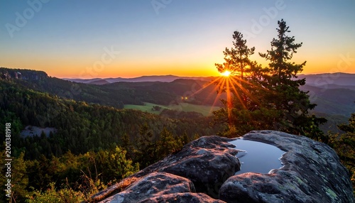 Landscape view of the first rising sun and reflection from a rock