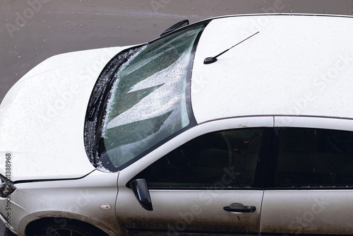 Schilderij op canvas Car after small hail. Hailstones accumulated on the windshield