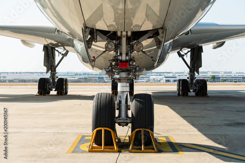 Front view of wide-body aircraft landing gear on tarmac