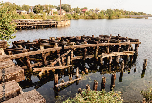 Quadro su tela Historic old steel railway bridge over calm river in Welland Ontario Canada