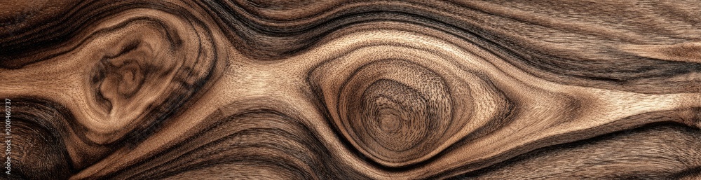 Fototapeta premium Swirling natural wood grain texture with dark and light brown tones