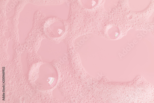 Beautiful transparent bubbles of cosmetic detergent, gel, shampoo, soap on a pink background. layout. A copy of the space. Top view