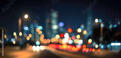 Soft focus night cityscape with bokeh lights of traffic and buildings