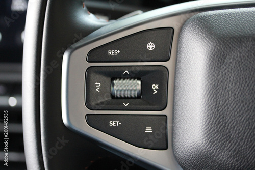Cruise control buttons on a new vehicle steering wheel