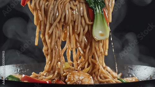 A close-up shot showcases a delicious plate of stir-fried noodles with succulent shrimp, vibrant vegetables, and a glistening sauce, presented against a dark, textured background.