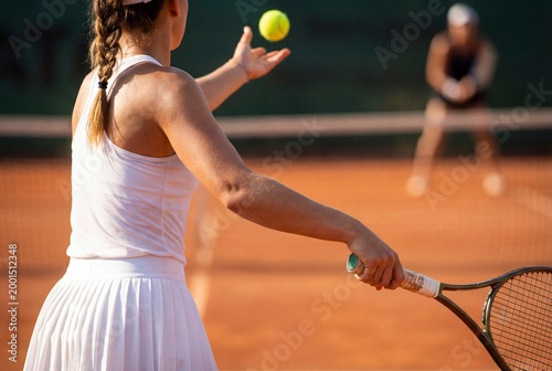 Professional Female Tennis Player Preparing for a Serve on a Sunny Court