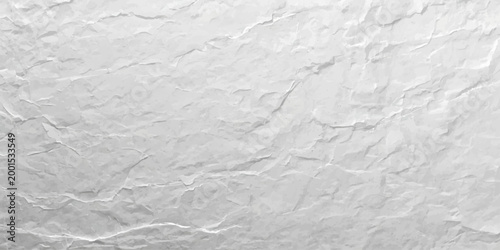 A blank white crumpled paper sheet with a rough wrinkled texture and old vintage creases creates a grunge pattern on the crushed surface of the material