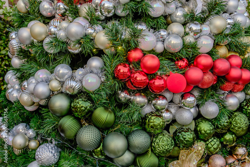 christmas tree decoration with many colorful shiny winkle balls in the garden