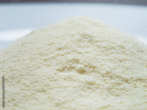 Milk powder flows smoothly into the container, showcasing the texture and color of the powder. Watch as the fine particles settle seamlessly.