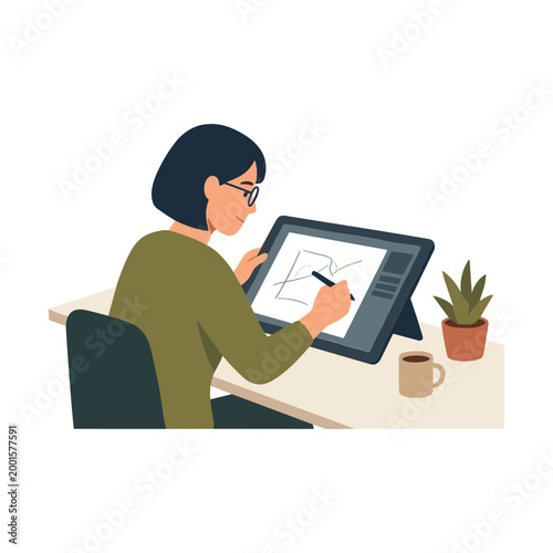 Woman sitting at desk drawing on graphics tablet with stylus