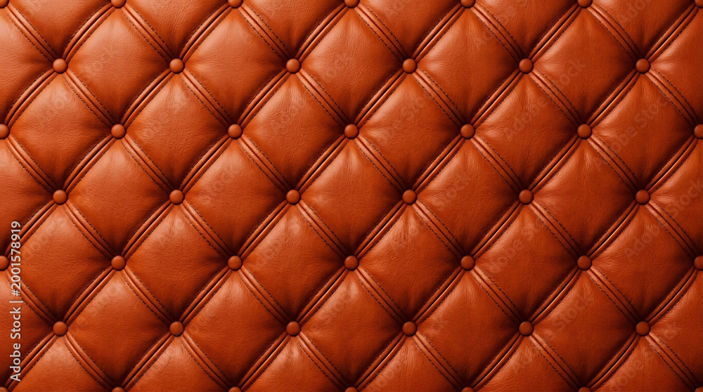 Fototapeta premium Luxury burnt orange tufted leather upholstery with diamond stitching pattern and button accents.