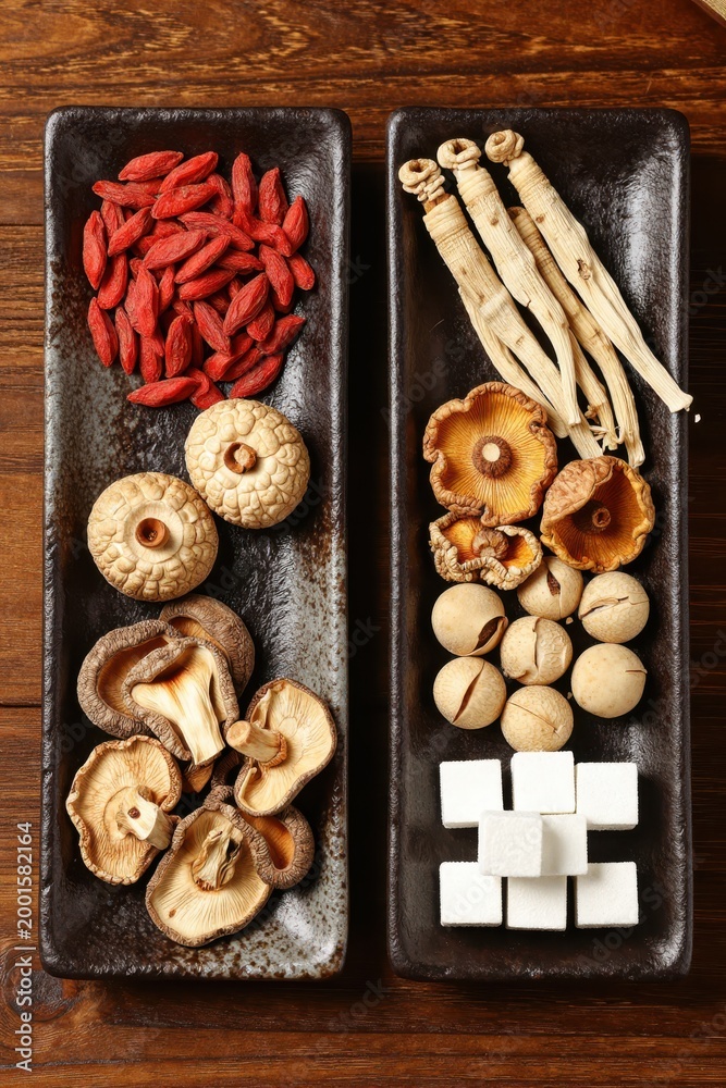 Fototapeta premium Dried Chili and Root Ingredients Arranged on Dark Slate
