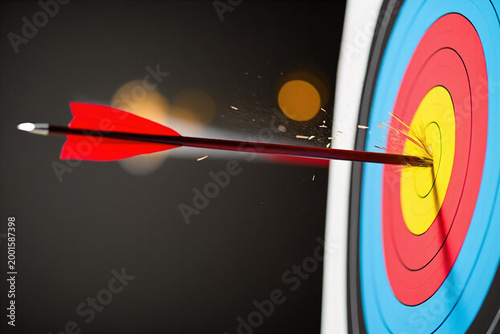 Archery target with arrow hitting bullseye