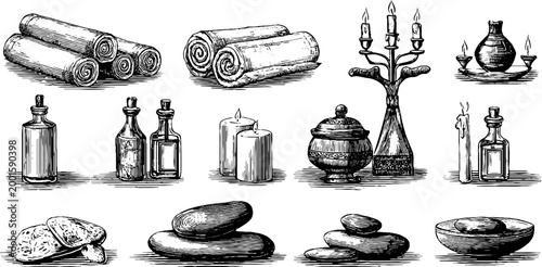 Spa essentials arranged with candles bottles and stones