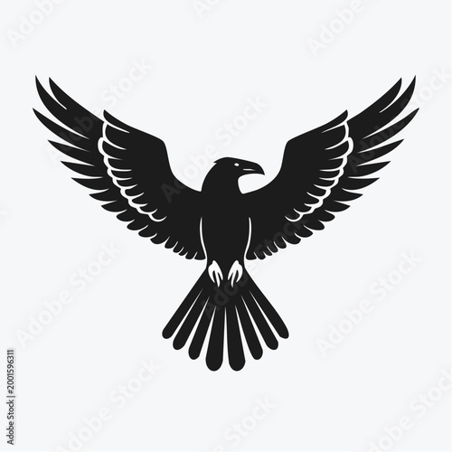 Black silhouette of a bird of prey with wings spread