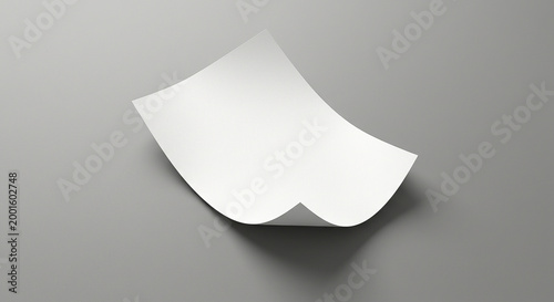 Blank sheet of paper resting on a flat surface in a minimal setting
