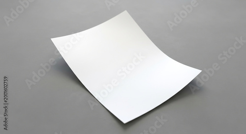 Blank sheet of paper on a gray surface in a simple indoor setting during daytime