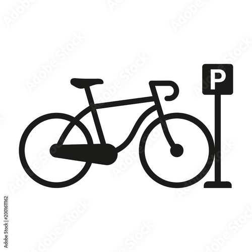 Bicycle parked next to parking sign