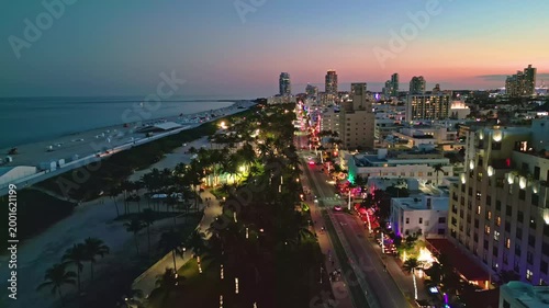 Miami beach iconic night skyline. Miami aerial panorama coastline. Miami south pointe shore dusk. Miami Ocean drive waterfront evening.