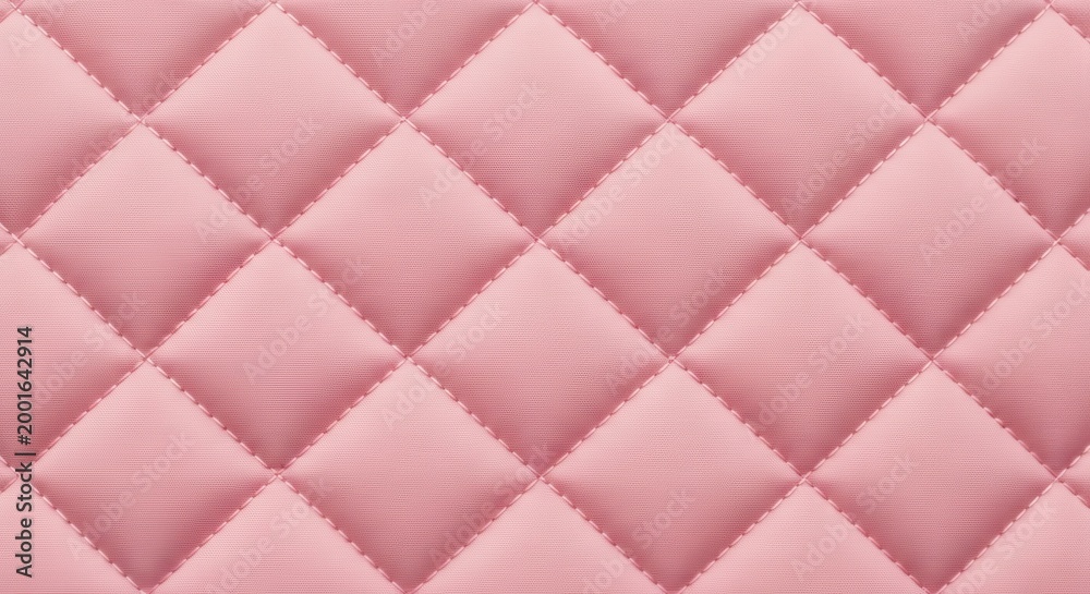 Obraz premium Pink quilted fabric with diamond shaped pattern and soft texture