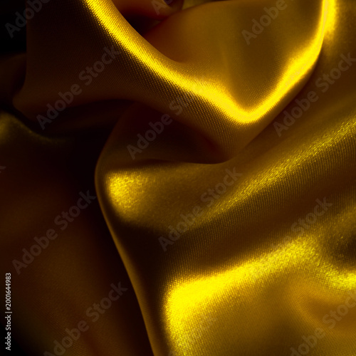 Photos Golden fabric background. Wrinkled cloth