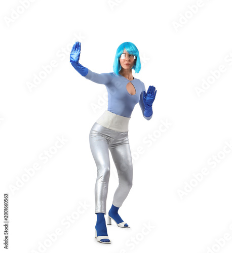 Young woman in futuristic costume with VR glasses playing on white background