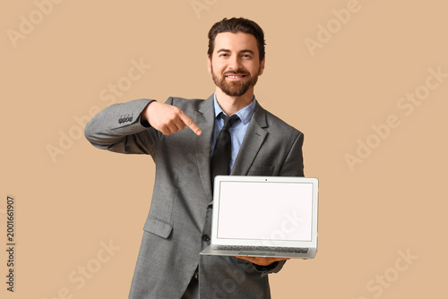 Young happy businessman poi...