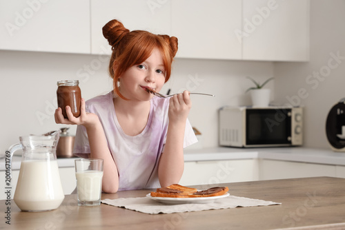 Cute girl eating sweet choc...