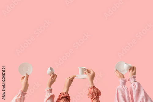 Female hands with cups and ...