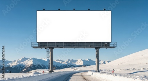 Blank billboard frame on a snowy mountain road with winter landscape and clear blue sky