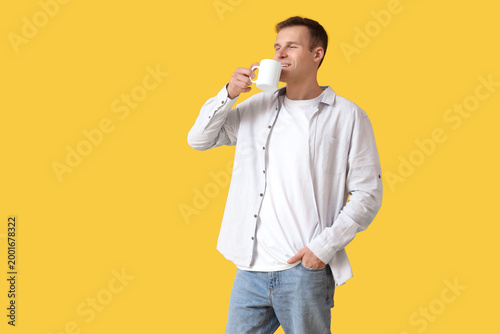 Handsome young man drinking...