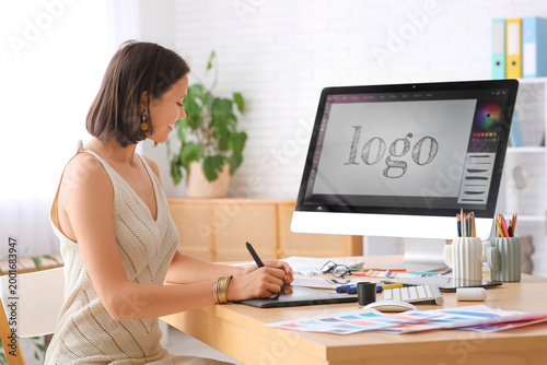 Young female designer worki...